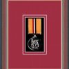 Dark walnut picture frame for one military medal with beaujolais mount