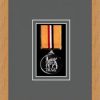 Light woodgrain picture frame for one military medal with grey mount