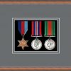 Teak picture frame for three military medals with grey mount