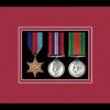 Black picture frame for three military medals with beaujolais mount