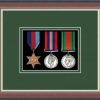 Dark walnut picture frame for three military medals with forest green mount