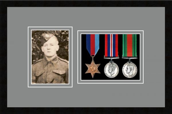 Black picture frame for three military medals/photo with grey mount