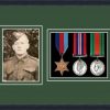 Black picture frame for three military medals/photo with forest green mount
