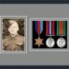 Black picture frame for three military medals/photo with grey mount