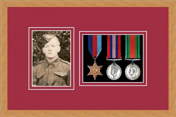 Light woodgrain picture frame for three military medals/photo with beaujolais mount