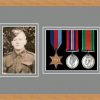 Light woodgrain picture frame for three military medals/photo with grey mount