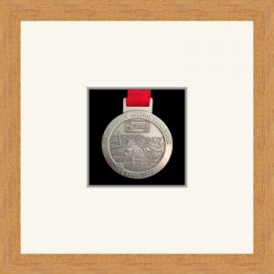 Light woodgrain picture frame for one marathon medal with antique white mount
