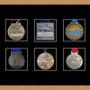 Light woodgrain picture frame for six marathon medals with black mount