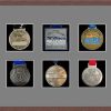 Dark woodgrain picture frame for six marathon medals with grey mount