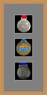 Light woodgrain picture frame for three marathon medals with grey mount