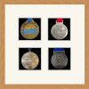 Light woodgrain picture frame for four marathon medals with antique white mount