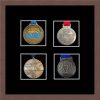 Dark woodgrain picture frame for four marathon medals with black mount