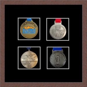 Dark woodgrain picture frame for four marathon medals with black mount