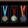 Dark woodgrain picture frame for three marathon medals with black mount