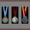 Dark woodgrain picture frame for three marathon medals with grey mount